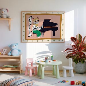 May include: A colorful illustration of a spotted cat wearing sunglasses playing a piano, framed and hanging on a white wall in a child's playroom. There are two small pink and white chairs and a green table with colorful pencils in front of the picture. A potted plant with red and green leaves is in the corner of the room.