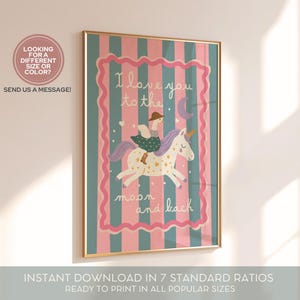 May include: A framed art print with a gold border features a whimsical illustration of a person riding a unicorn. The artwork has a pink and teal striped background with the text "I love you to the moon and back."