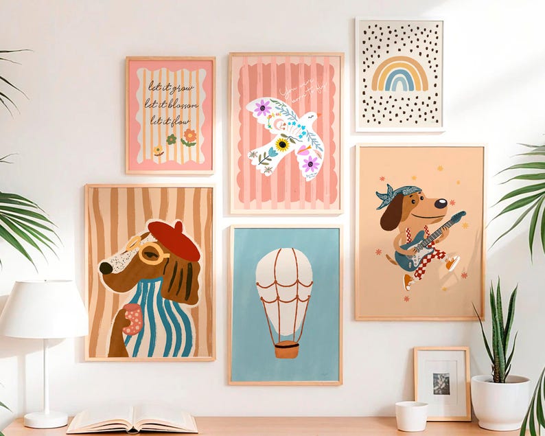 May include: A collection of framed art prints featuring whimsical illustrations. The prints include a dog with glasses and a beret, a dog playing guitar, a hot air balloon, a dove, a rainbow, and text that reads "let it grow, let it blossom, let it flow."