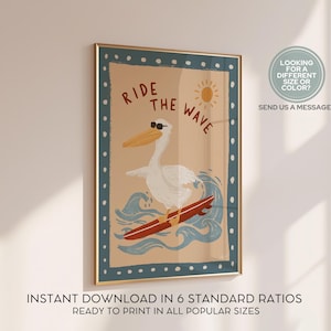 May include: A framed art print featuring a cartoon pelican wearing sunglasses and surfing on a red surfboard. The words "RIDE THE WAVE" are above the pelican. The print has a tan background with blue waves and a sun. The frame has a blue border.