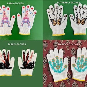 May include: Four pairs of white cotton work gloves with different embroidered designs. The designs include a Parisian Eiffel Tower, butterflies, bunnies, and marigolds.