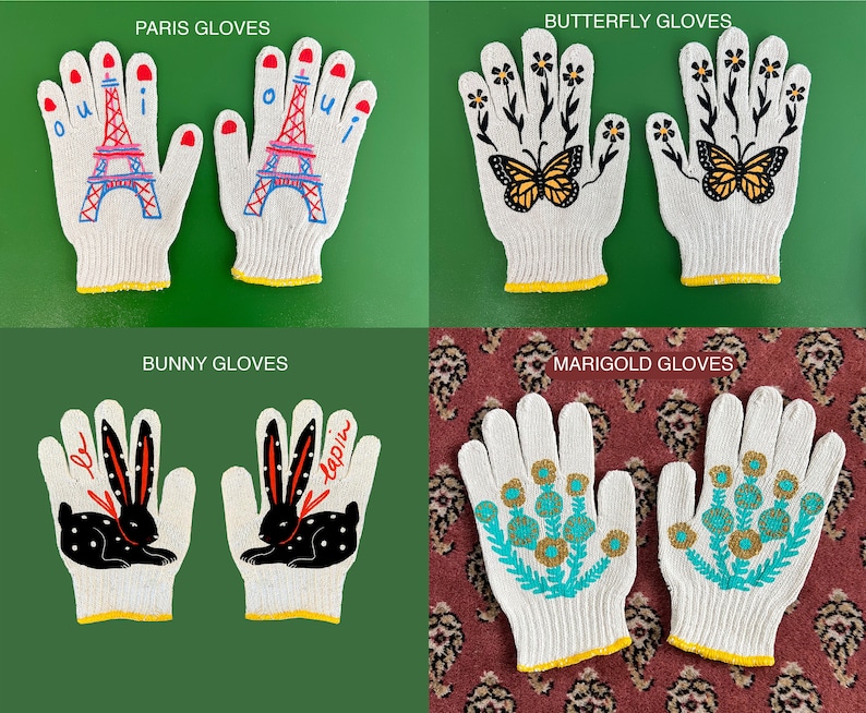 May include: Four pairs of white cotton work gloves with different embroidered designs. The designs include a Parisian Eiffel Tower, butterflies, a bunny rabbit, and marigolds.