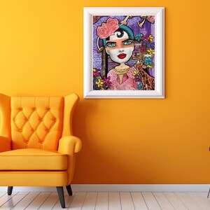 May include: A framed illustration of a woman with a pink flower crown and a purple background. She is wearing a pink dress and has a giraffe next to her. The illustration is surrounded by a white frame.