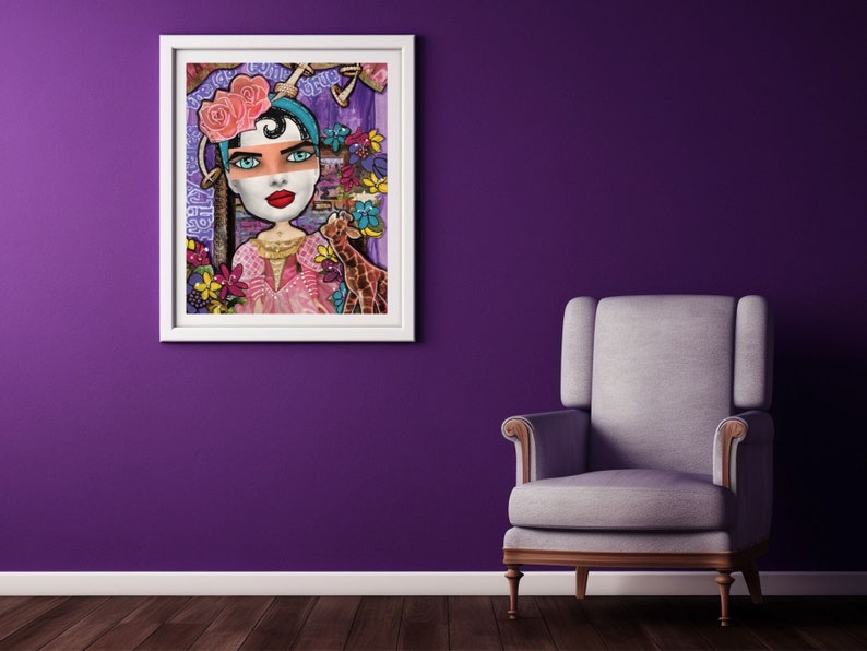 May include: A colorful mixed media painting of a woman with a pink flower crown and a giraffe. The woman is wearing a pink dress and has blue eyes and red lips. The painting is framed in white and has the text "Pretty, Tough, Brave" written on it.