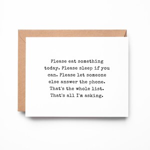 May include: A white greeting card with black typewriter-style text that reads: Please eat something today. Please sleep if you can. Please let someone else answer the phone. That's the whole list. That's all I'm asking. The card sits on a brown envelope.