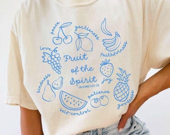May include: A white t-shirt with a blue graphic of fruit and the text "Fruit of the Spirit" with the scripture reference "Galatians 5:22-23".