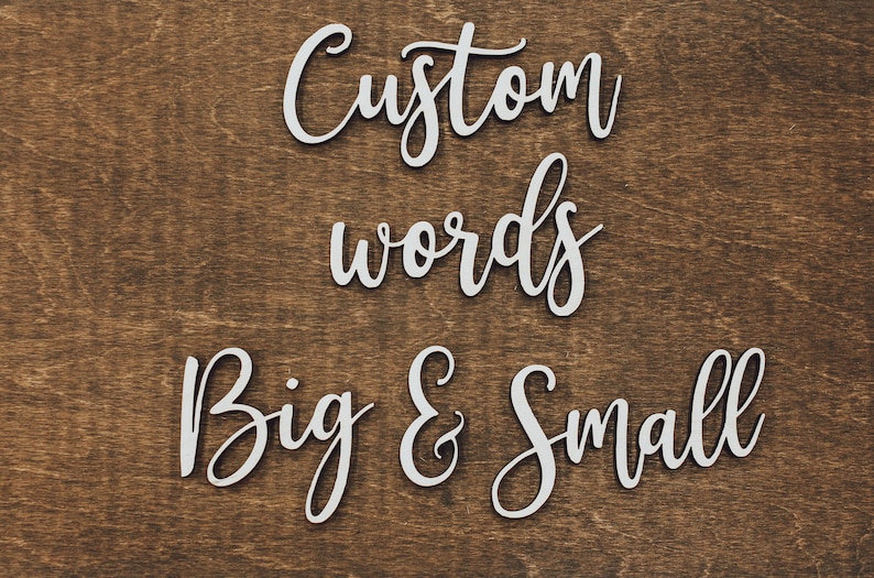 Artisan birch unfinished wood script words that say "custom words big & small" on a dark walnut stained background