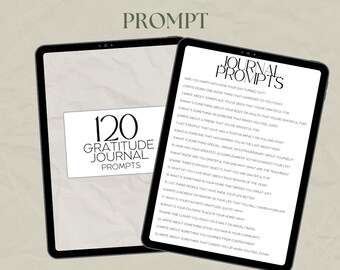 May include: Two digital tablets displaying a gratitude journal with 120 prompts. The text on the screen reads "120 Gratitude Journal Prompts" and "Journal Prompts". The background is a neutral beige color.