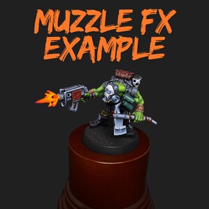 May include: A miniature green figure with a gas mask and a weapon, firing a flame. The figure is on a wooden base, with the words "MUZZLE FX EXAMPLE" in orange above. The figure is holding a gun with red accents.