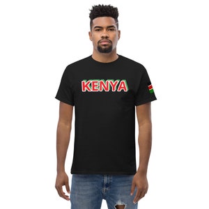 May include: A black t-shirt with the word "KENYA" printed in red and green letters. The shirt has a small Kenyan flag patch on the right sleeve.