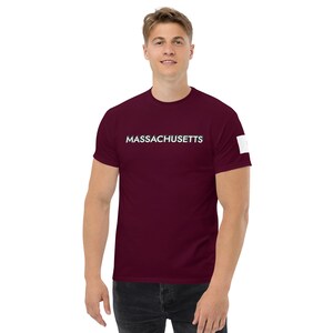 May include: A maroon t-shirt with the text "MASSACHUSETTS" printed in white on the front.