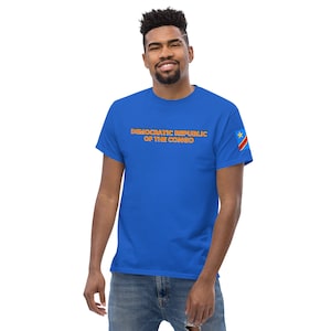 May include: A royal blue t-shirt with the text "DEMOCRATIC REPUBLIC OF THE CONGO" in orange with a red outline. The right sleeve features the flag of the Democratic Republic of the Congo.