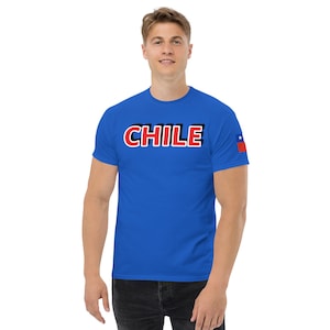 May include: A royal blue t-shirt with a black outline and red text that says "CHILE". A small Chilean flag is on the right sleeve.