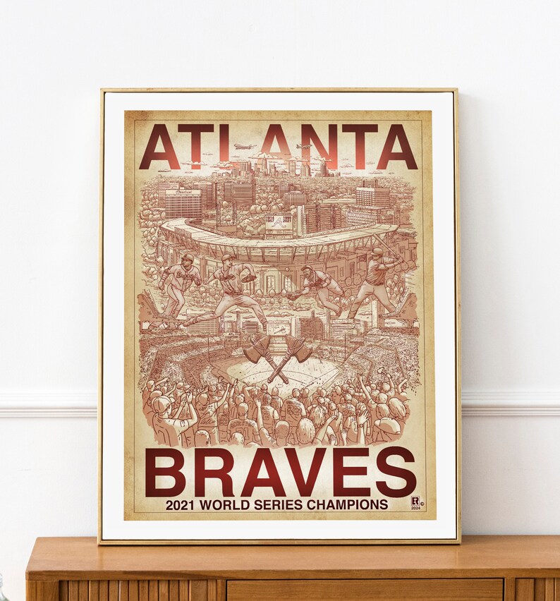 May include: A vintage-style poster with a red and white color scheme featuring the Atlanta Braves logo and the text "Atlanta Braves 2021 World Series Champions". The poster depicts a baseball field with players in action and a crowd of fans cheering.