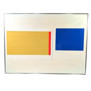 May include: Abstract art print featuring a rectangular composition. A large yellow rectangle with a red vertical stripe is on the left, and a blue rectangle is on the right. The artwork is framed in a silver metal frame.