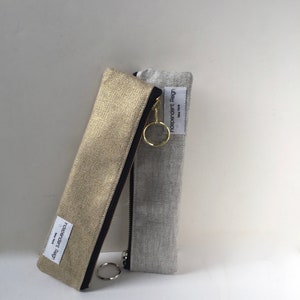Slender zippered pouch in gold or silver metallic fabric.  Skinny zipper bag for small odds and ends.