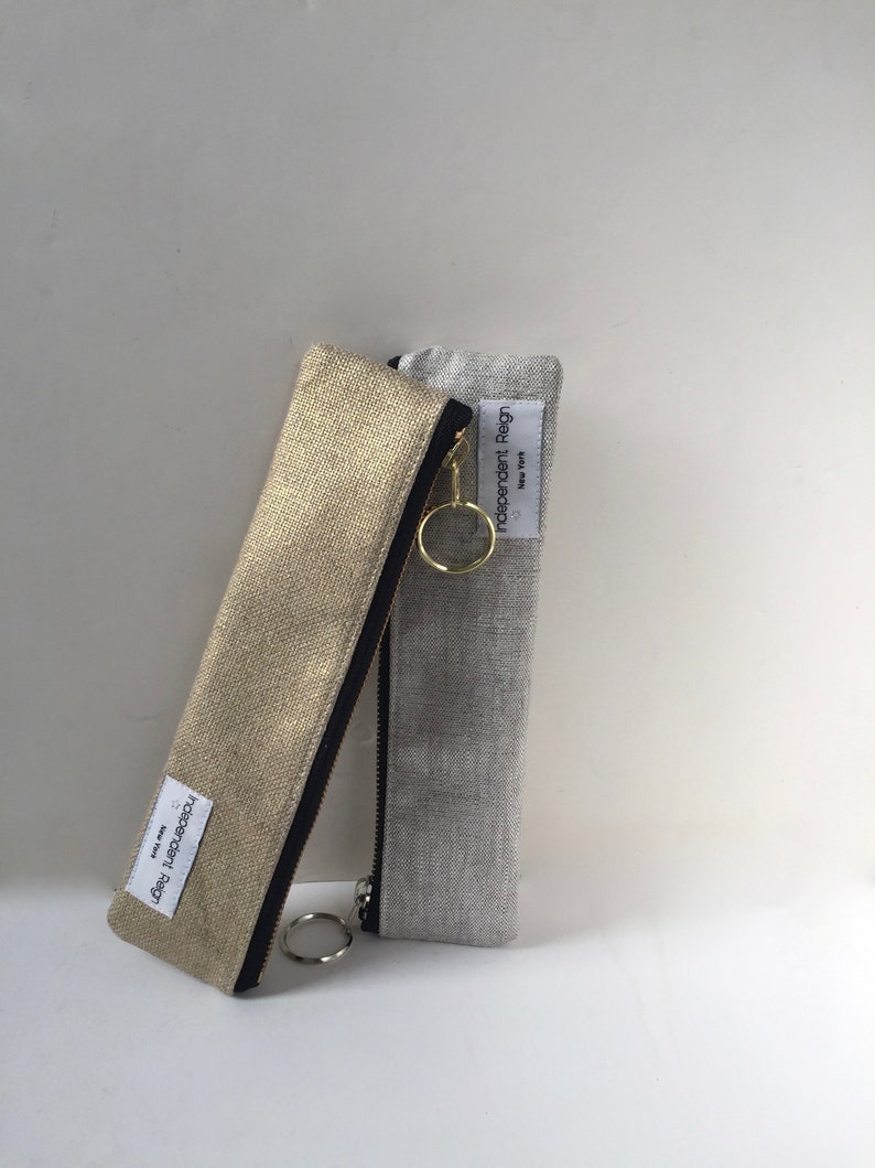 Slender zippered pouch in gold or silver metallic fabric.  Skinny zipper bag for small odds and ends.