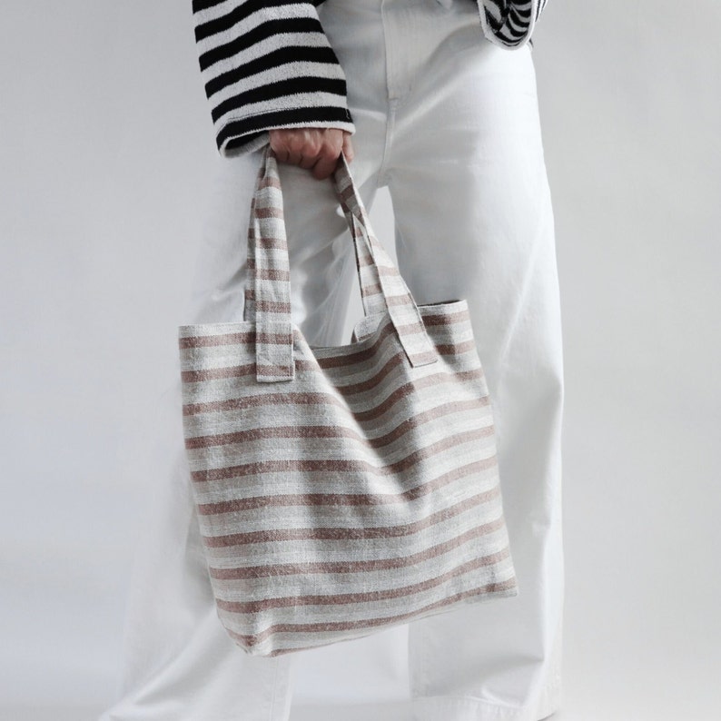 Striped woven tote bag in neutral colors.