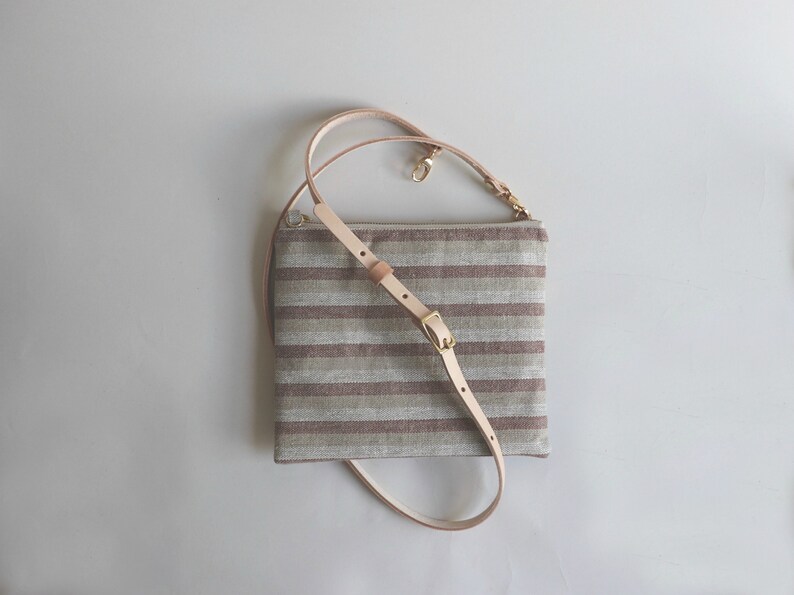 Cute crossbody bag in Neutral striped linen and a natural leather crossbody strap.