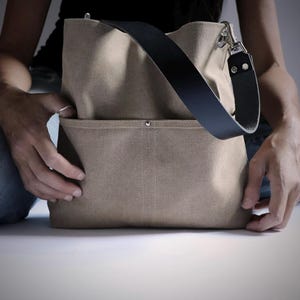 Canvas shoulder bag with one strap and 2 front pockets.  Summer purse in tan color.