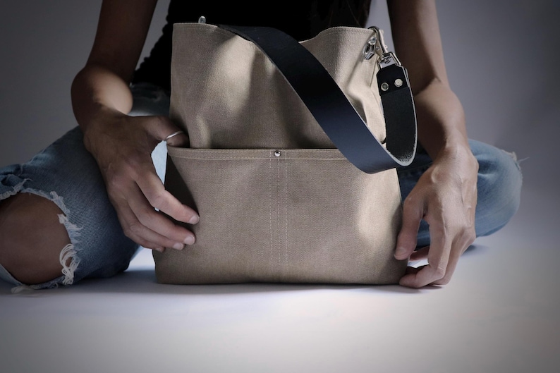 Canvas shoulder bag with one strap and 2 front pockets.  Summer purse in tan color.