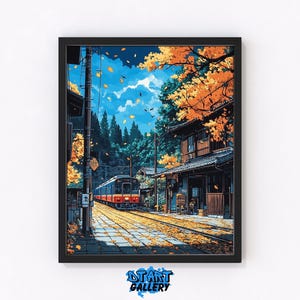 May include: Framed art print of a Japanese train station in autumn. The artwork features a train on tracks, a traditional building, and trees with orange leaves under a blue sky. The print is framed in a black border.