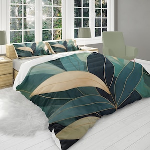 May include: A bed with a duvet cover and pillow shams featuring a large-scale leaf design in shades of teal, beige, and gold. The bedding is on a white bed frame, with a white rug and wooden nightstands on either side.