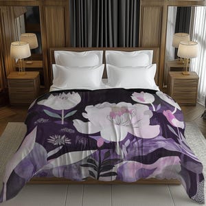 May include: A floral patterned blanket featuring large white and pink flowers on a dark purple background. The blanket is draped over a bed with white pillows and a wooden headboard. The room has wooden paneling and curtains.