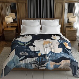 May include: A floral patterned blanket on a bed. The blanket features large white and gold flowers against a dark blue background. The bed has white pillows and is in a room with wooden paneling and lamps.