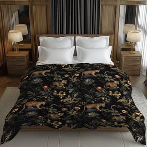 May include: A black bedspread with a jungle-themed design featuring leopards, foliage, and flowers. The pattern includes shades of green, orange, and brown. The bedspread is draped over a bed with white pillows.