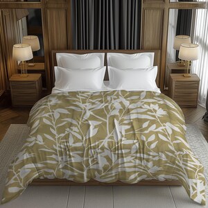 May include: A bed with white pillows and a duvet cover with a white leaf pattern on a golden-yellow background. The bed is in a room with wooden panelling, bedside tables with lamps, and dark grey curtains.