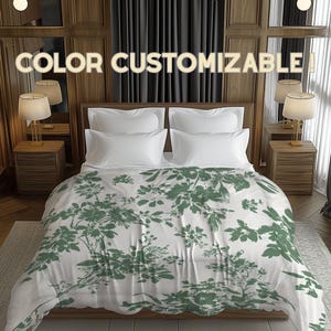 May include: A bed with white pillows and a green floral patterned comforter. The text "COLOR CUSTOMIZABLE" is displayed above the bed. The room has wooden paneling, bedside tables with lamps, and dark curtains.