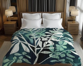 May include: A bed with a white comforter and pillows, topped with a teal and white leaf-patterned blanket. The room has wooden paneling, bedside tables with lamps, and dark gray curtains.