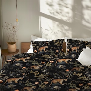 May include: Black bedding set with a leopard print design. The set includes a duvet cover and pillowcases. The leopard print features a repeating pattern of leopards, foliage, and flowers in shades of brown, green, and orange. The background is black.