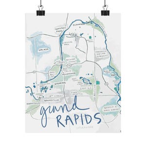 May include: A watercolour map print of Grand Rapids, Michigan, showing the Grand River and surrounding parks. The map includes the text "Grand Rapids" in a handwritten font, and various neighbourhoods and landmarks.