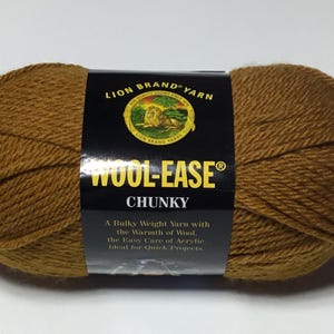 May include: A ball of brown Wool-Ease Chunky yarn by Lion Brand Yarn. The label reads "A Bulky Weight Yarn with the Warmth of Wool, the Easy Care of Acrylic. Ideal for Quick Projects."