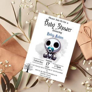Op de afbeelding: Een witte baby shower uitnodiging met een cartoonillustratie van een baby Jack Skellington uit The Nightmare Before Christmas. De uitnodiging bevat de tekst "Please Join Us for a Baby Shower Honoring Baby Adam" en details voor het evenement.