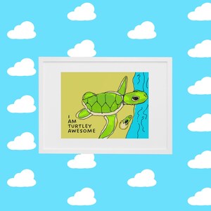 May include: A framed print with a yellow background featuring a green sea turtle swimming in blue water. The text "I am turtley awesome" is written in black below the turtle.