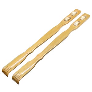 May include: Two wooden back scratchers with rounded handles and multiple raised bumps for scratching. The scratchers are made of natural light brown bamboo.