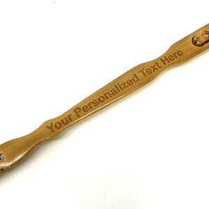 May include: A wooden back scratcher with a textured head and a handle that says "Your Personalized Text Here".