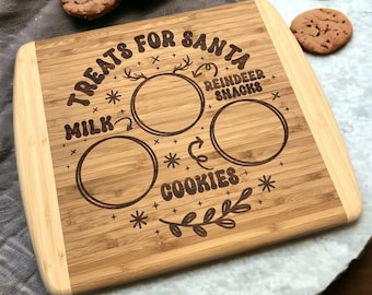 May include: A brown bamboo cutting board with the text "Treats for Santa" and spaces for milk and cookies. The board has a decorative reindeer design and the words "Reindeer Snacks".