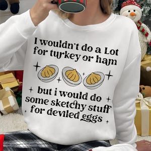 May include: White sweatshirt with the text "I wouldn't do a Lot for turkey or ham + but I would do + some sketchy stuff for deviled eggs +" and a graphic of three deviled eggs.