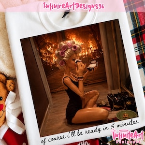 May include: A white t-shirt featuring a graphic print of a doll with blonde hair in pink rollers, wearing a black bodysuit, applying makeup. The background shows a house on fire. The text reads, "of course i'll be ready in 5 minutes".