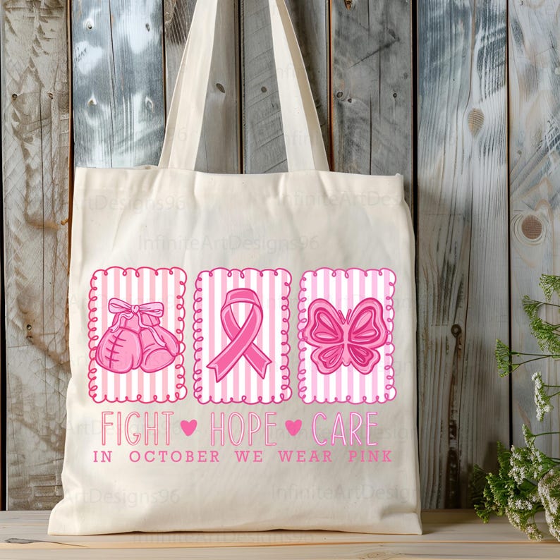 May include: Cream-colored tote bag with pink graphics and text. The design includes pink boxing gloves, a ribbon, and a butterfly, each within a striped frame. Text reads "FIGHT HOPE CARE" and "IN OCTOBER WE WEAR PINK".