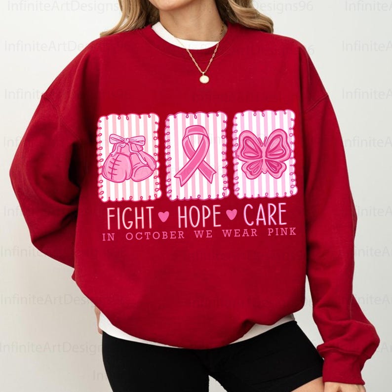 May include: A red sweatshirt with a white crew neck featuring three pink graphic designs. The designs include boxing gloves, a ribbon, and a butterfly, with the words "FIGHT HOPE CARE" and "IN OCTOBER WE WEAR PINK" printed below.