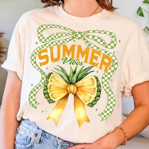 May include: A white t-shirt with a green and white checkered bow, a pineapple bow, and the text "Summer Vibes".