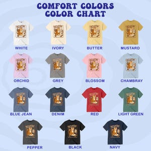 Puede incluir: Una carta de colores muestra camisetas de varios colores, cada una con un gr&aacute;fico de "Bakery" y un gato. Los colores incluyen blanco, marfil, mantequilla, mostaza, orqu&iacute;dea, gris, flor, chambray, azul vaquero, mezclilla, rojo, verde claro, pimienta, negro y marino.