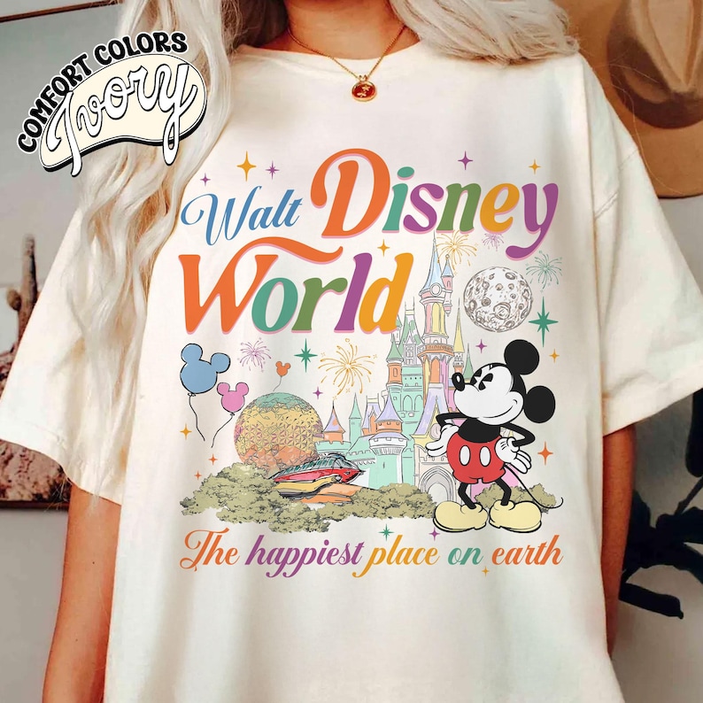 May include: A white ceramic mug with a black handle and the text "But First, Coffee" in a handwritten style. The mug is on a white surface. The mug is likely for hot beverages.