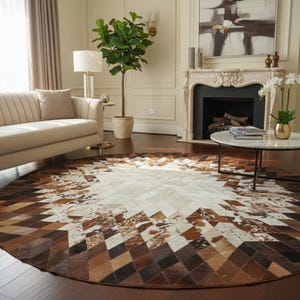 May include: A circular rug featuring a geometric design in brown, white, and tan hues. The rug is placed in a living room with a beige sofa, a fireplace, and a coffee table.