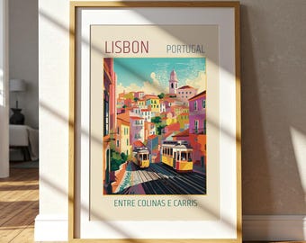 May include: Framed art print of Lisbon, Portugal, featuring a colorful illustration of the city with yellow trams on tracks. The print has the text "LISBON PORTUGAL" and "ENTRE COLINAS E CARRIS" in a gold frame.